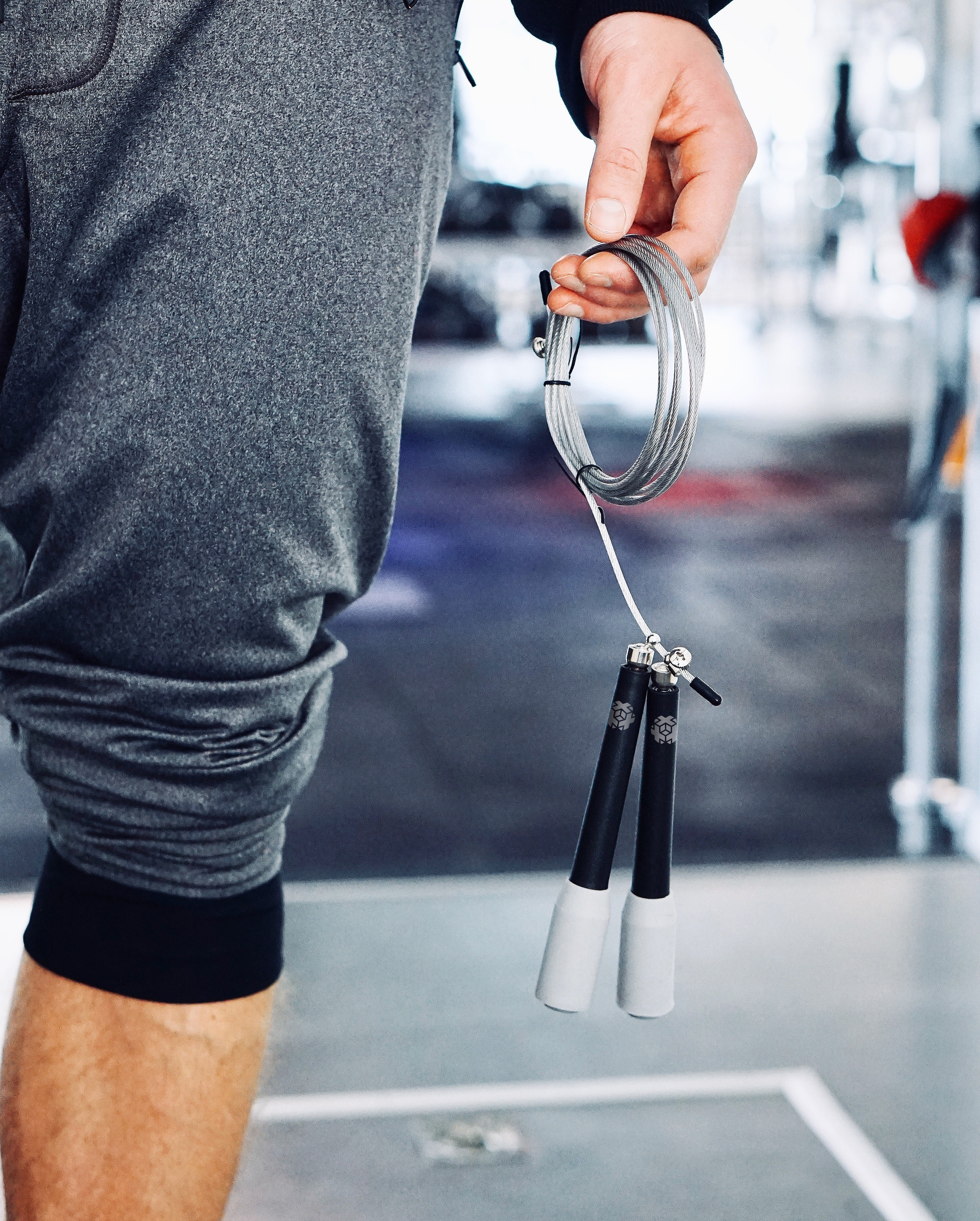 mann in fitnesstudio mit springseil